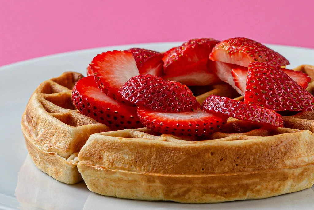 Brunch menu in Aruba with fresh waffle topped with strawberries at Waffles Beach House