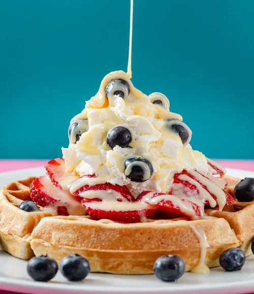 Best breakfast in Aruba with fresh waffles, strawberries, blueberries, and cream at Waffles Beach House