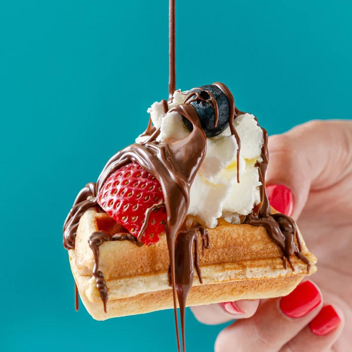 Best breakfast in Aruba with sweet waffle topped with chocolate, strawberries and cream at Waffles Beach House
